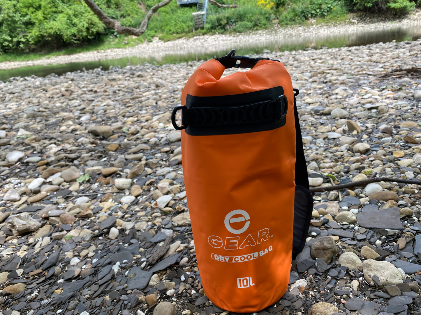 Orange Dry Bag Cooler on Rocks
